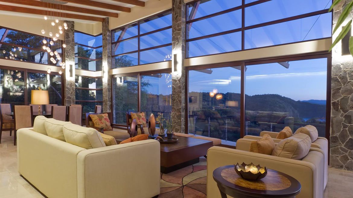 a living room with a lot of windows and furniture