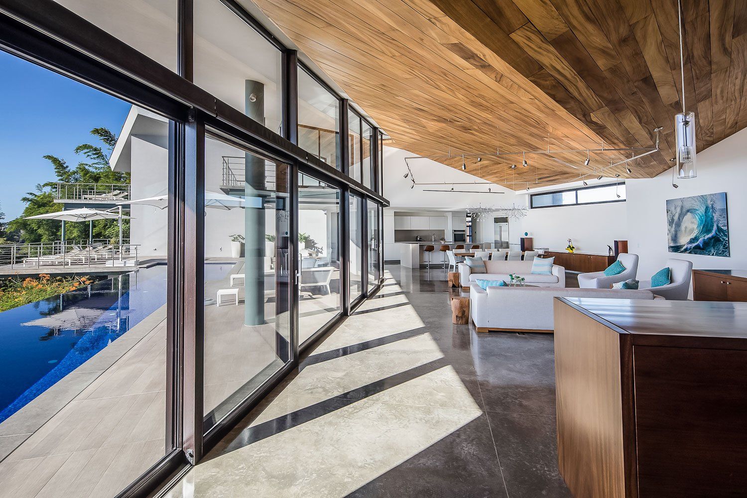a large room with a lot of windows and a wooden ceiling