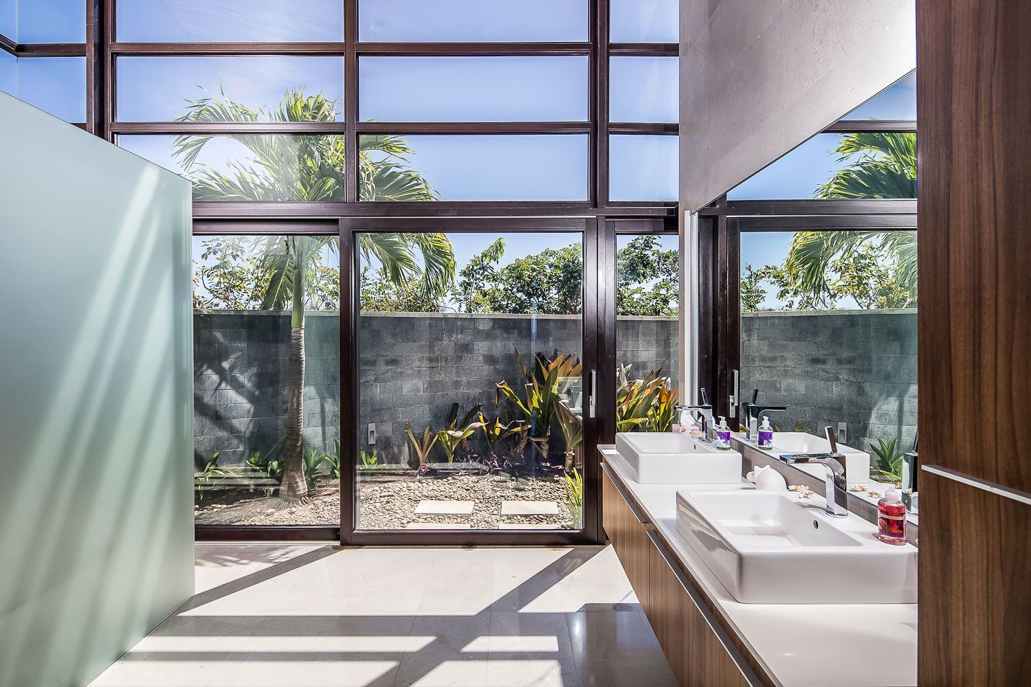 a bathroom with two sinks and a large window