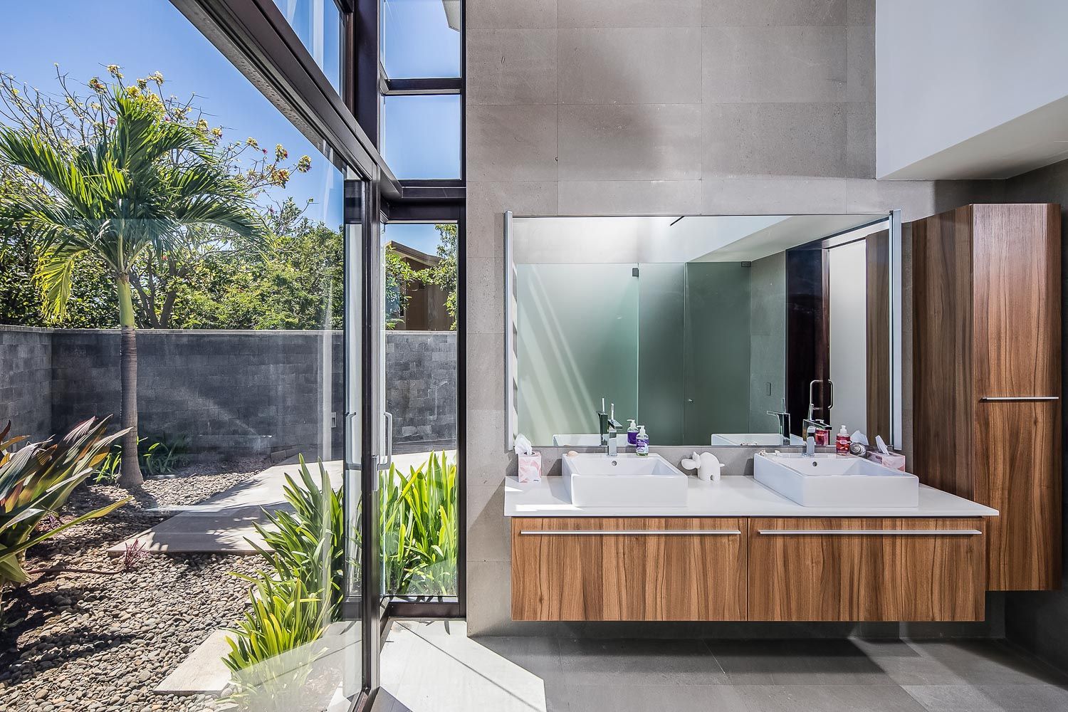 a bathroom with two sinks and a large mirror