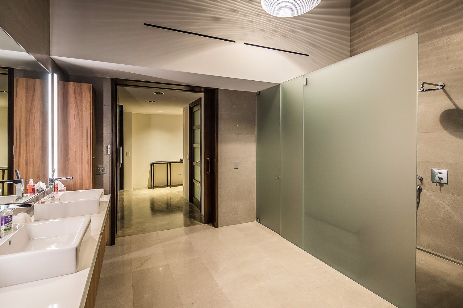 a bathroom with two sinks and a walk in shower .