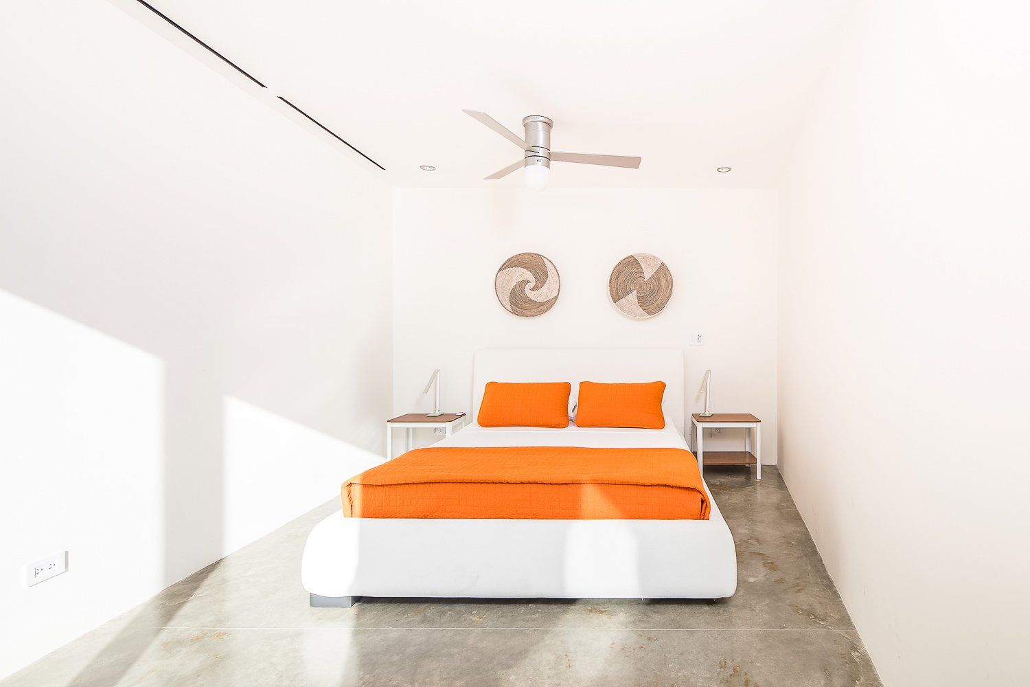 a bedroom with a bed and a ceiling fan