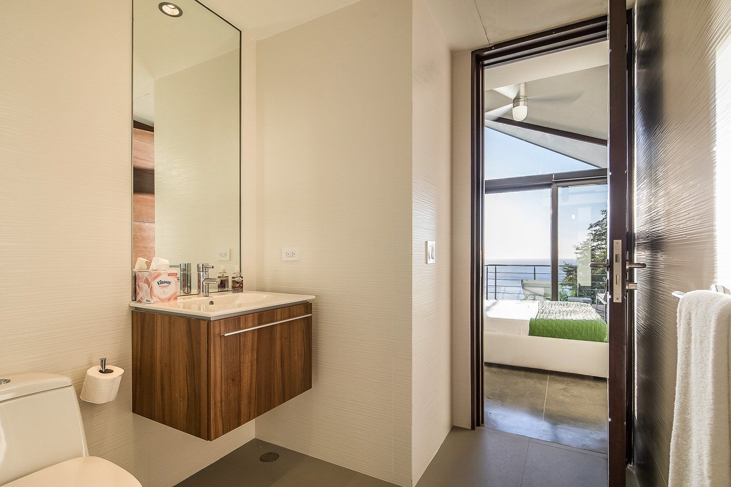 a bathroom with a toilet , sink and mirror