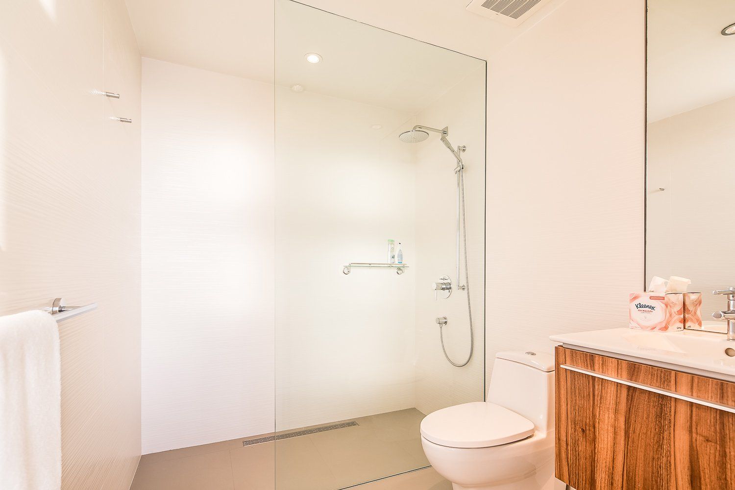 a bathroom with a toilet , sink and shower .
