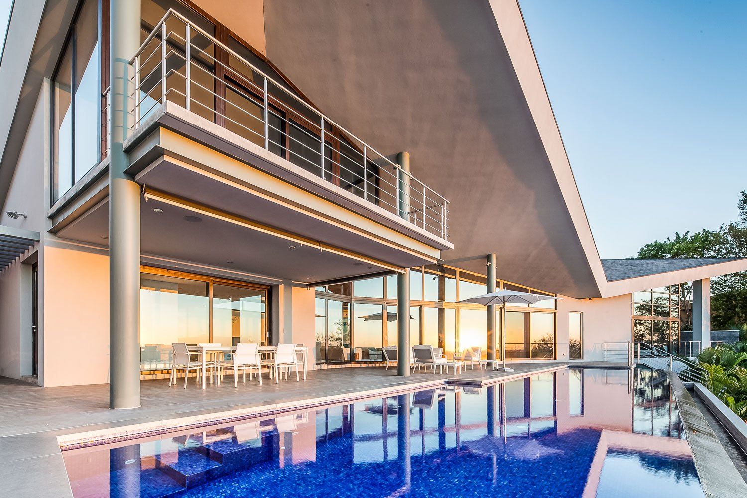 a large house with a large swimming pool in front of it