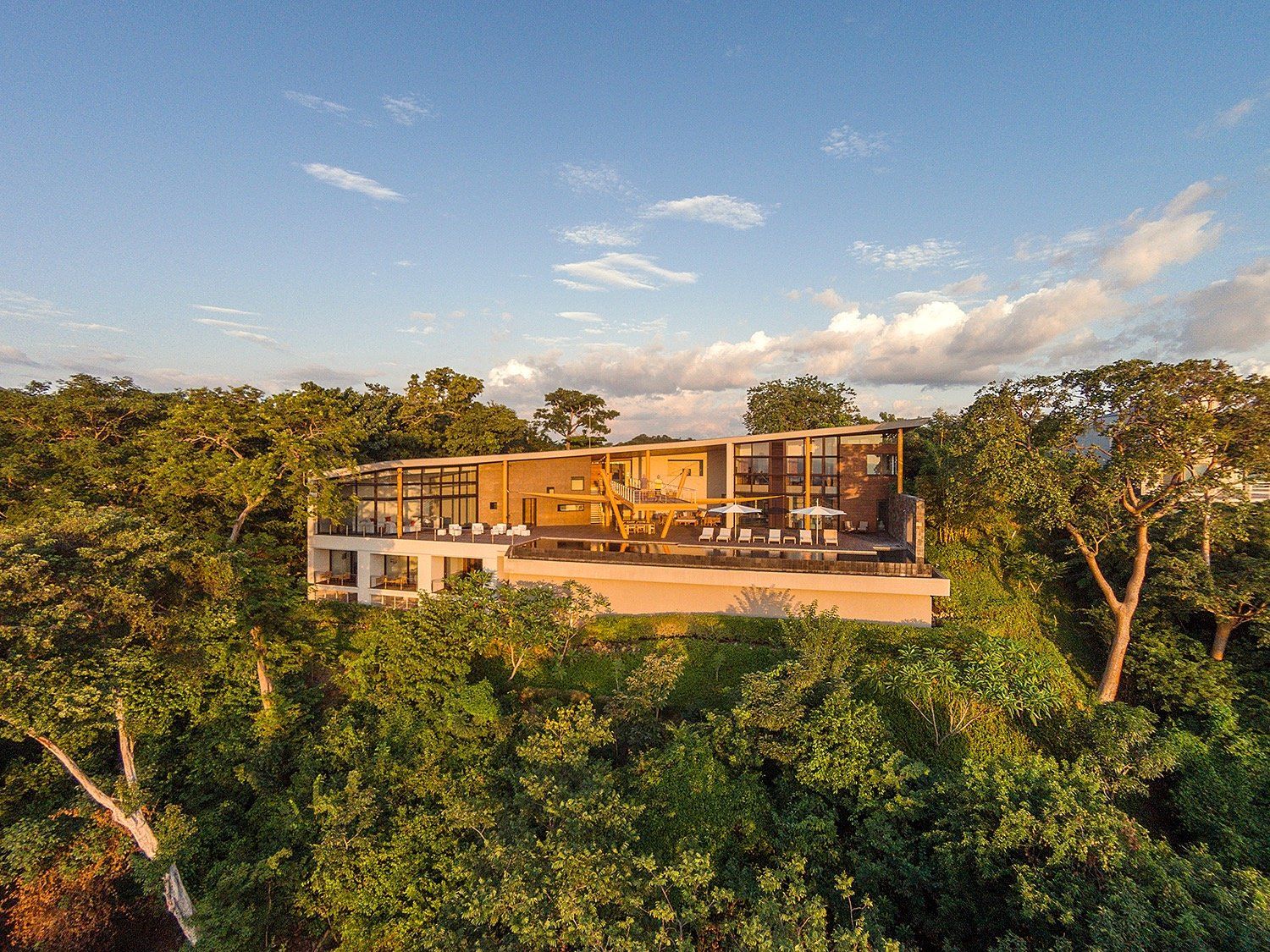 an aerial view of a house in the middle of a forest