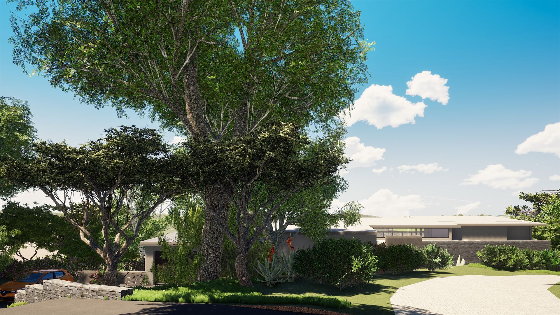 a large tree is in the middle of a lush green field in front of a house .