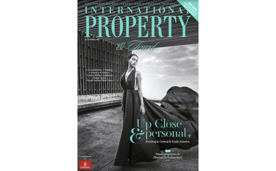 a woman in a long black dress is on the cover of a magazine .