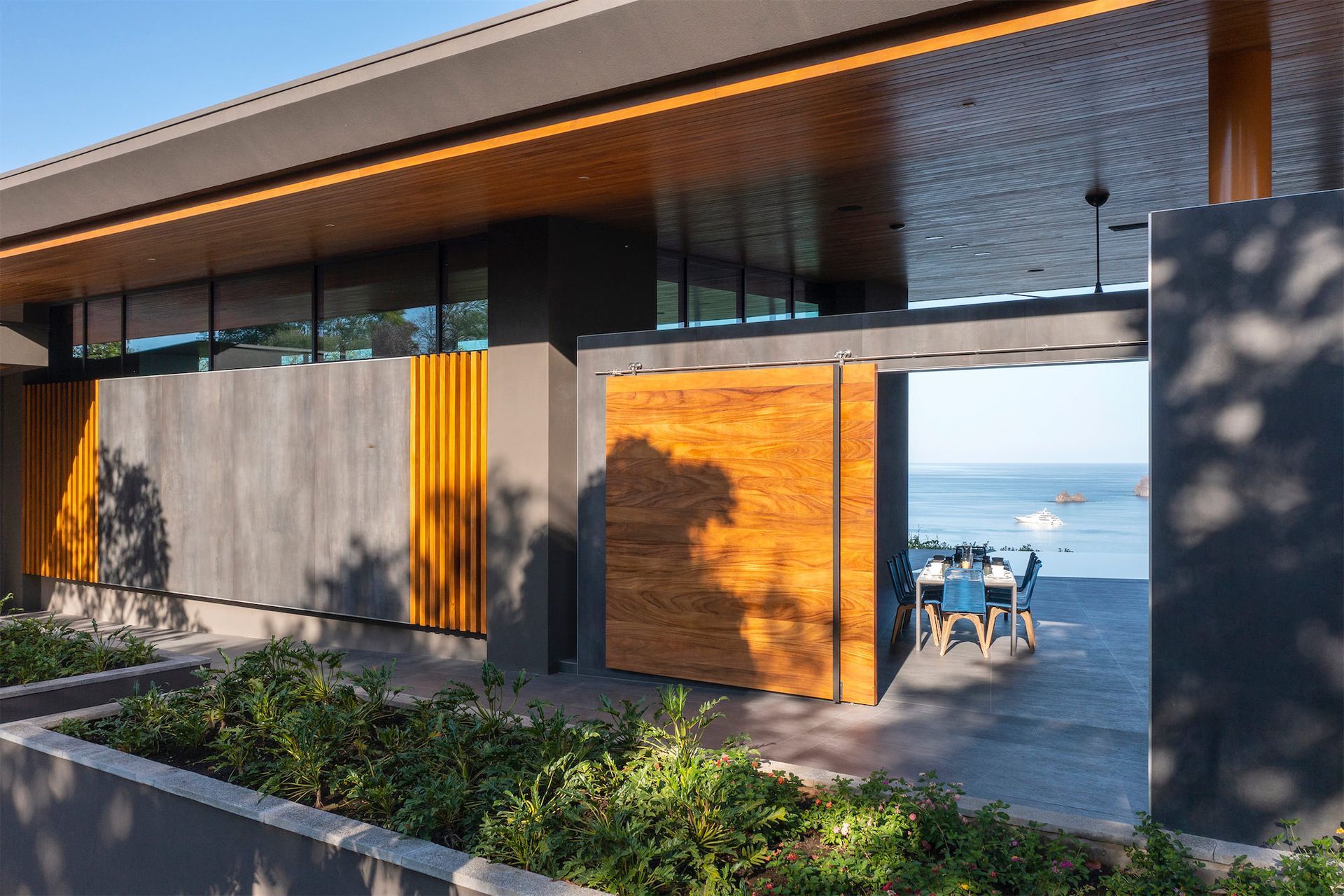 a building with a wooden door that leads to the ocean