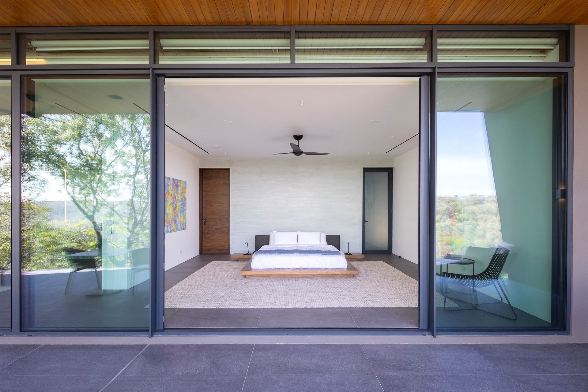 a bedroom with a large bed and sliding glass doors