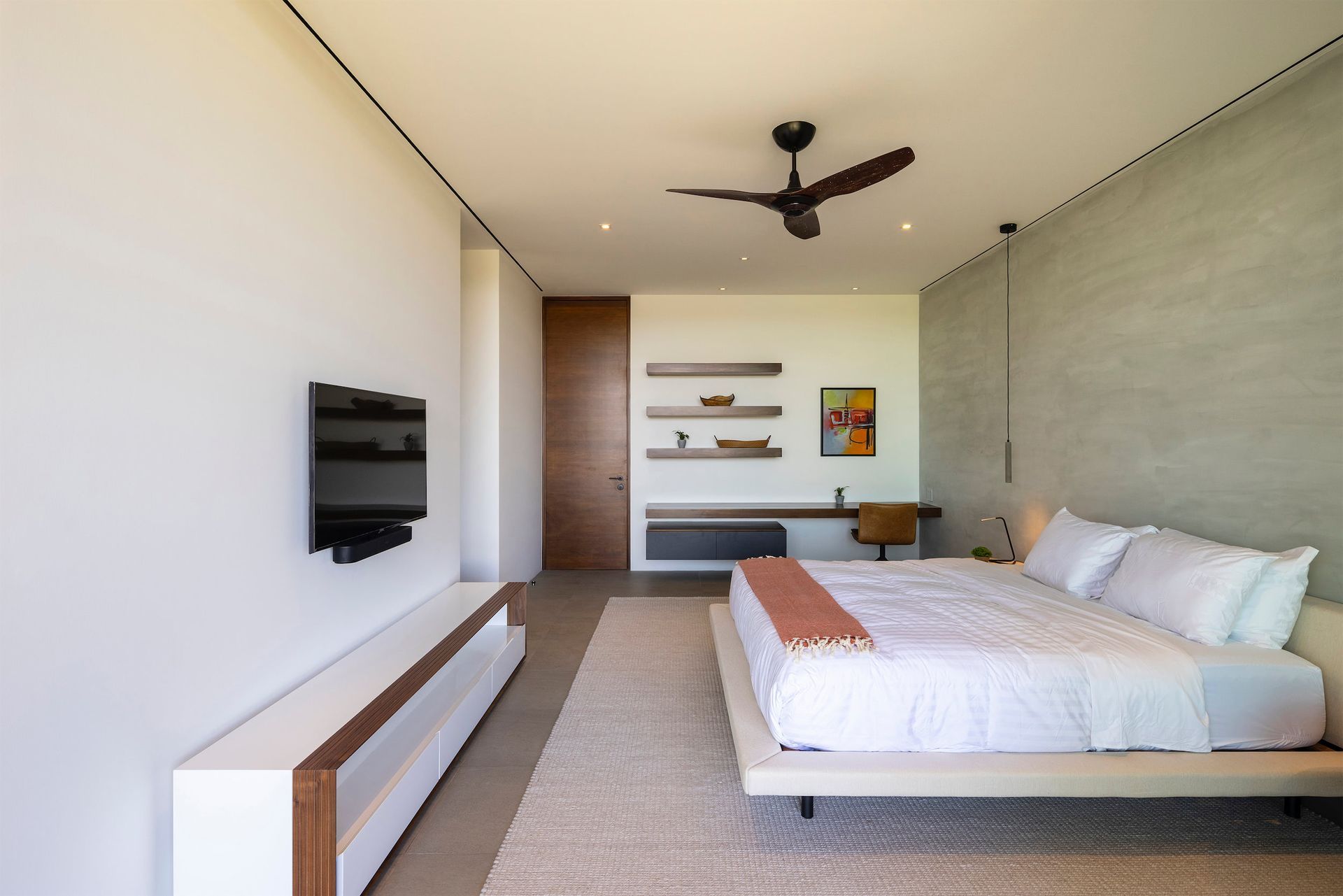 a bedroom with a large bed and a flat screen tv