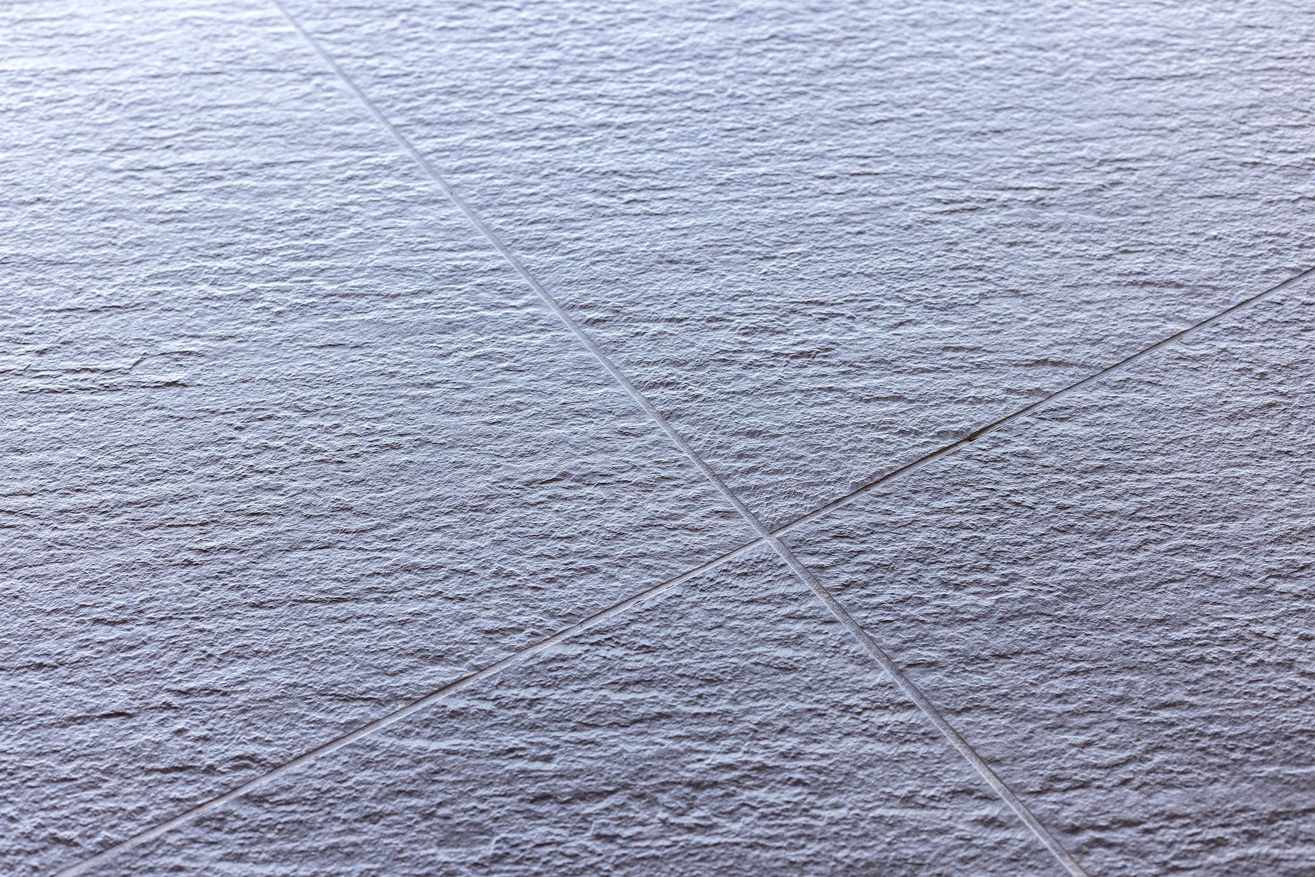 a close up of a gray tile floor .