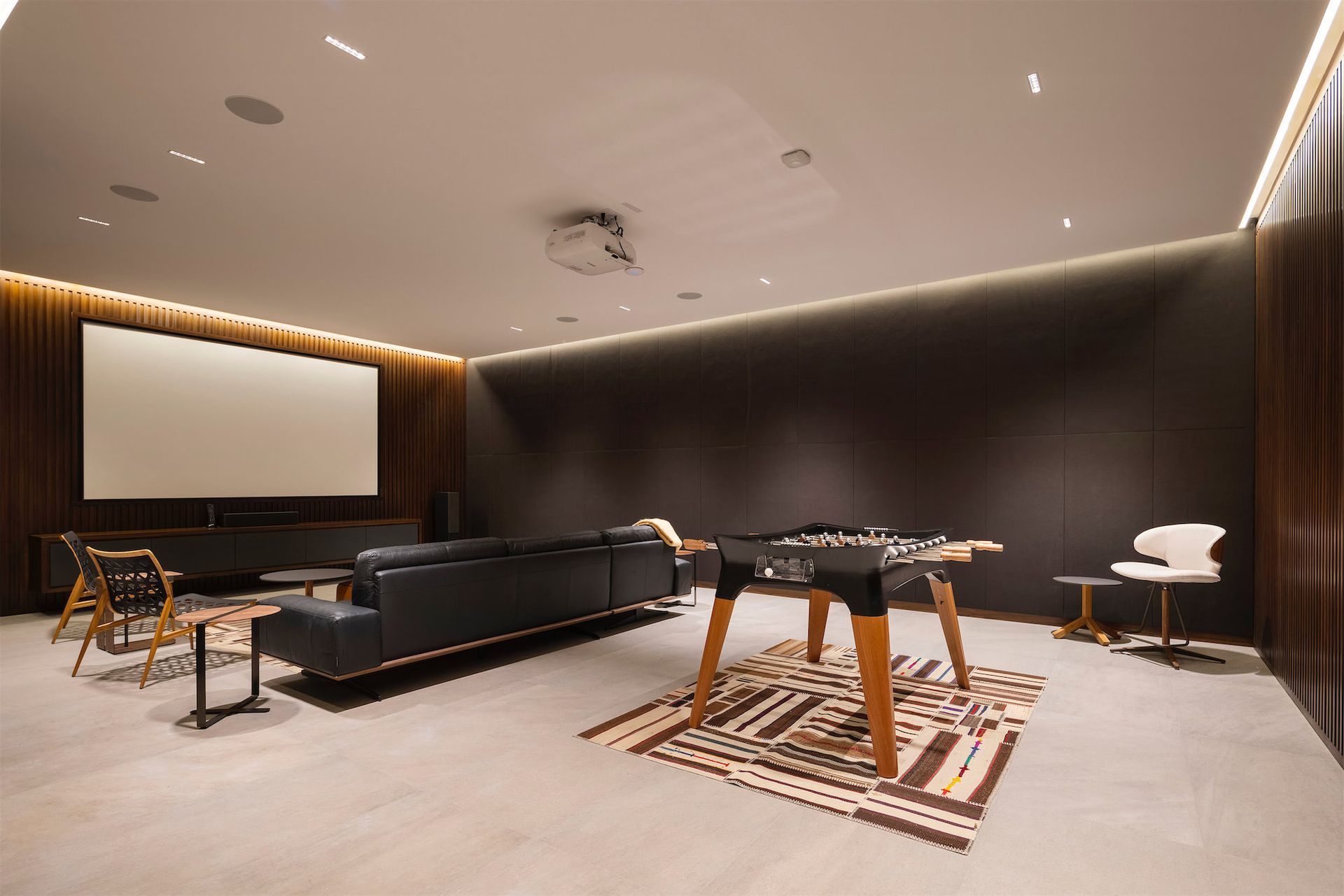 a living room with a couch and a game table
