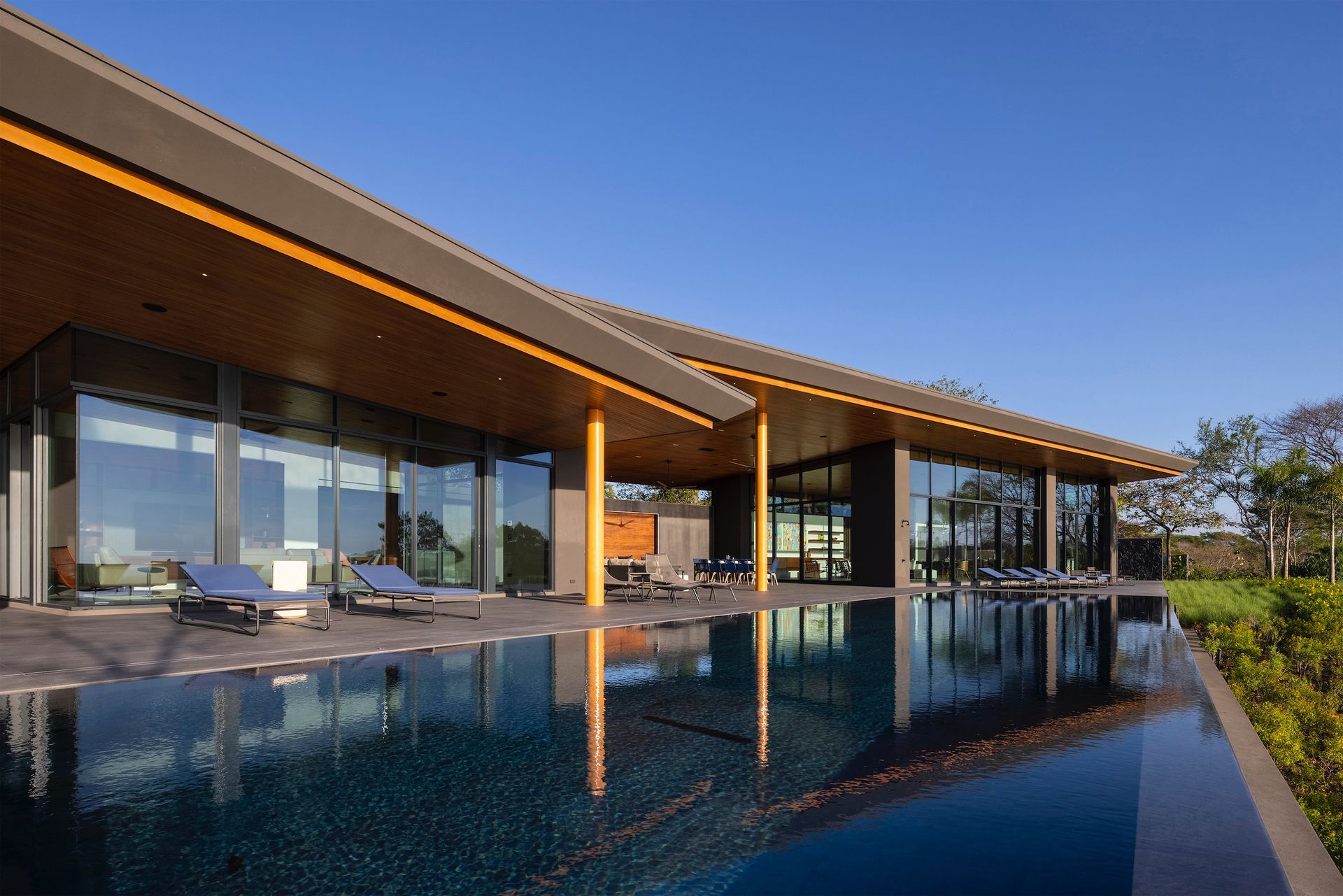 a large house with a large swimming pool in front of it