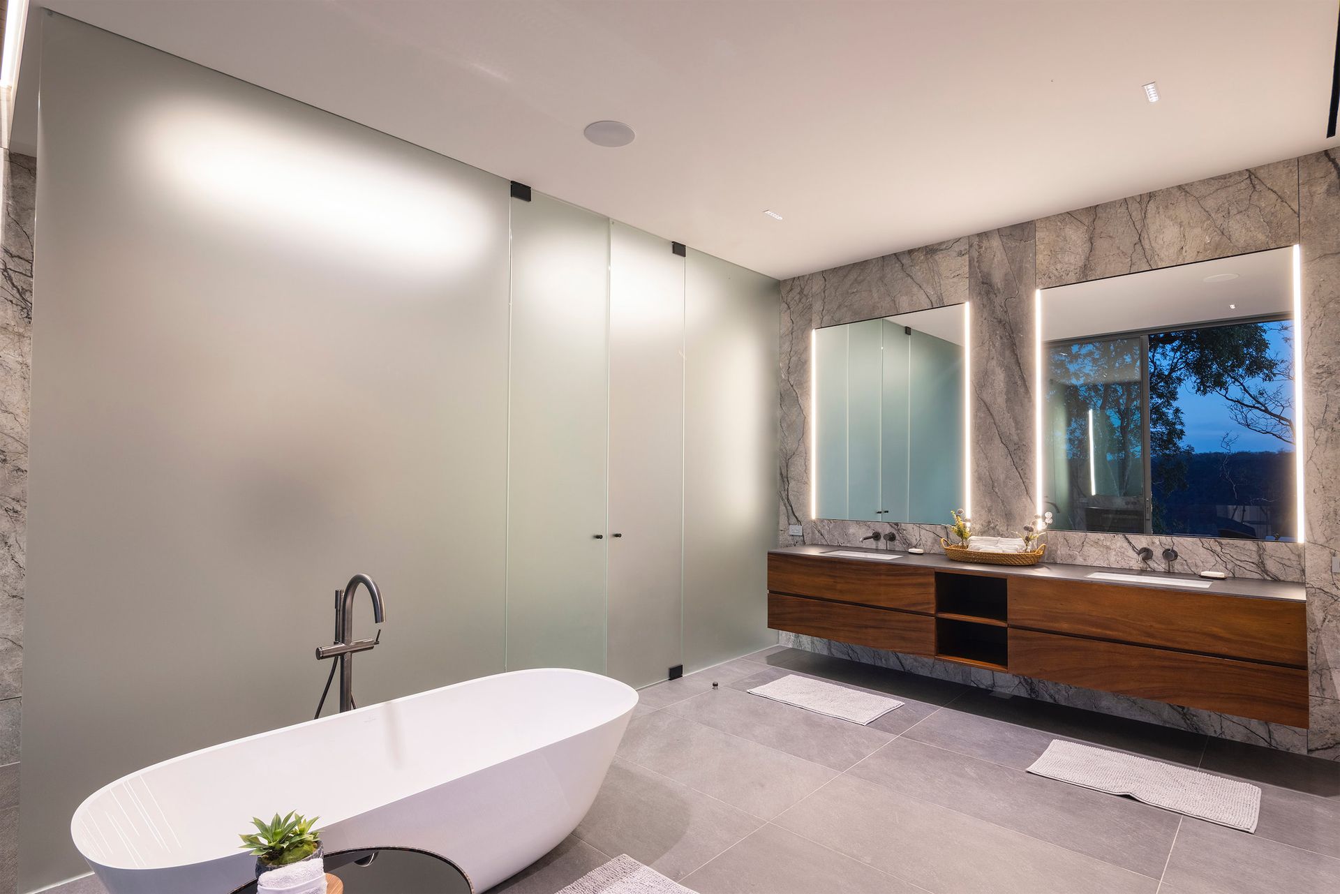 a bathroom with a bathtub and two sinks