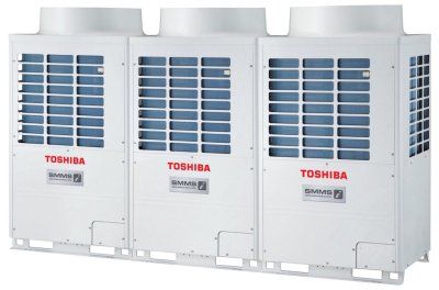 three toshiba air conditioners are sitting next to each other on a white background .