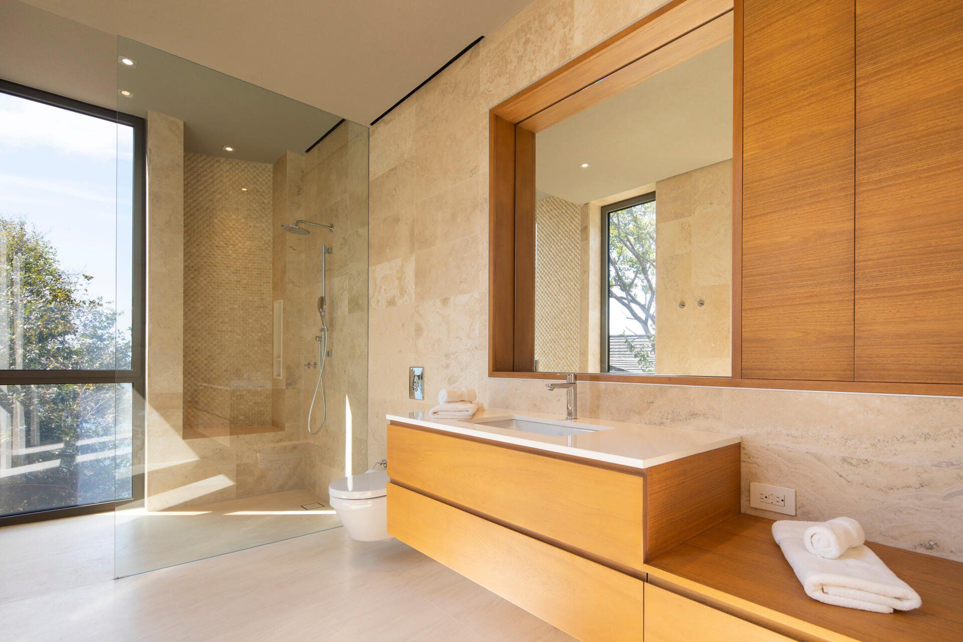 a bathroom with a sink , mirror and toilet .