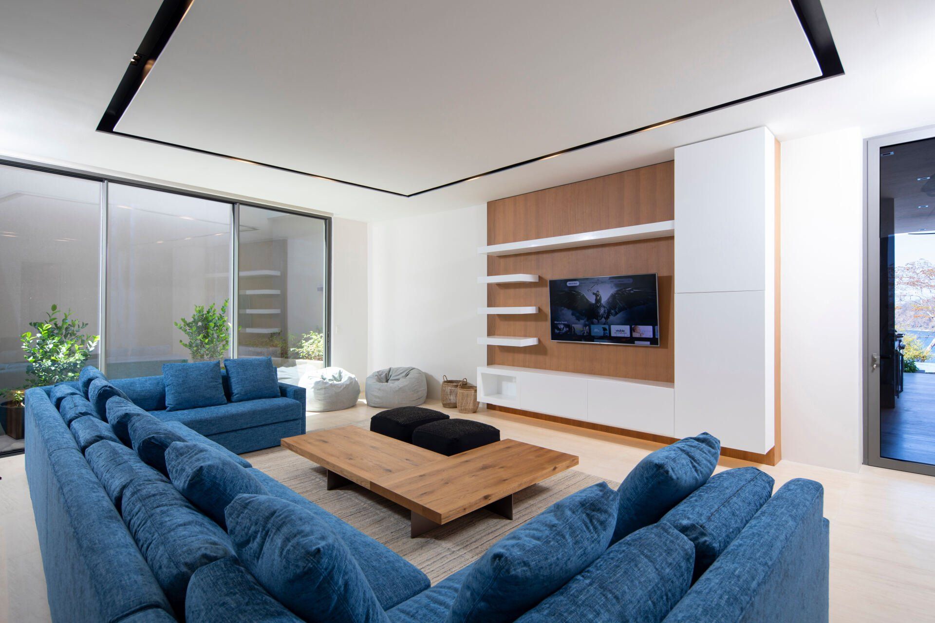 a living room with blue couches and a flat screen tv