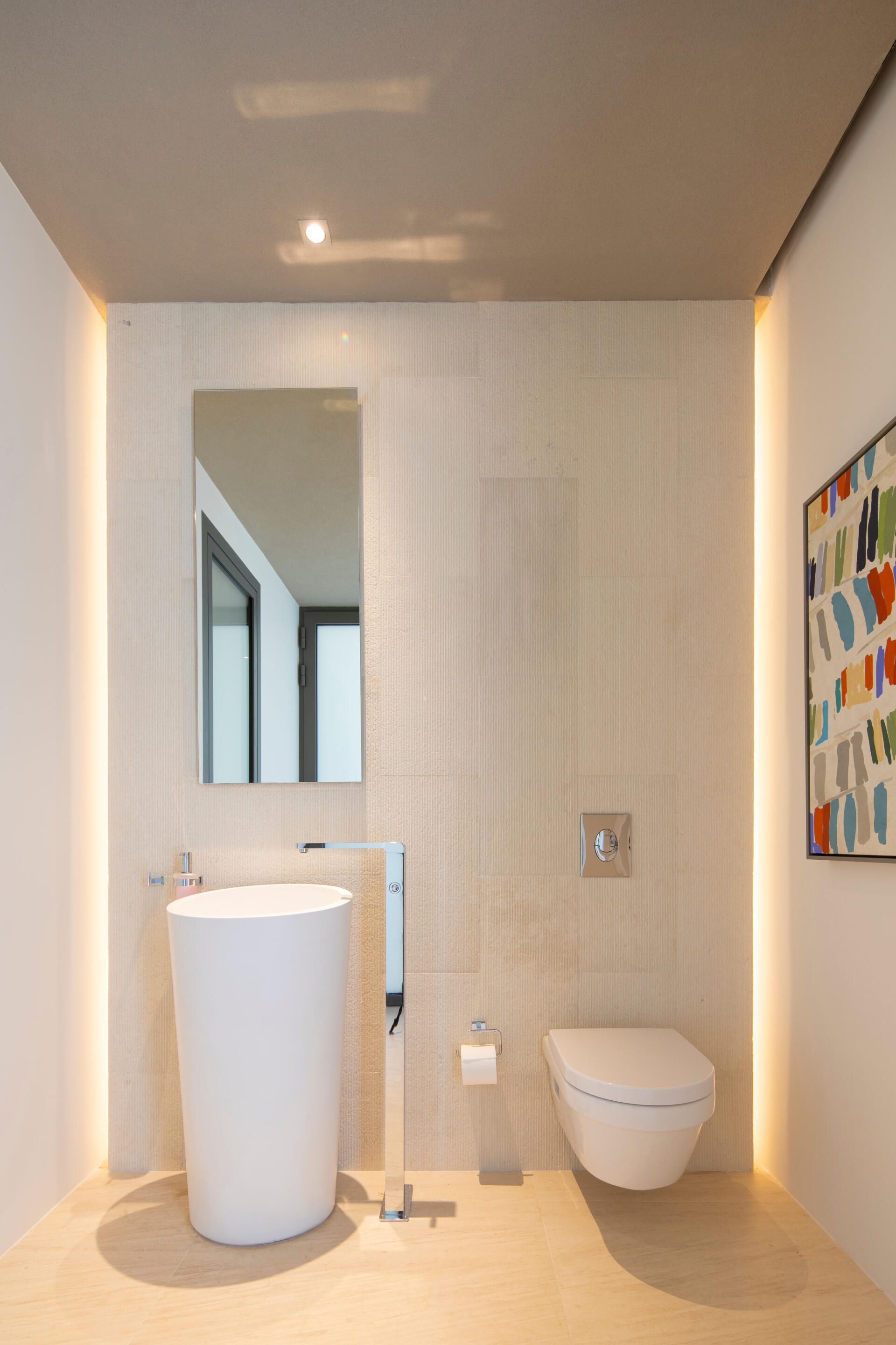 a bathroom with a sink , toilet and mirror .