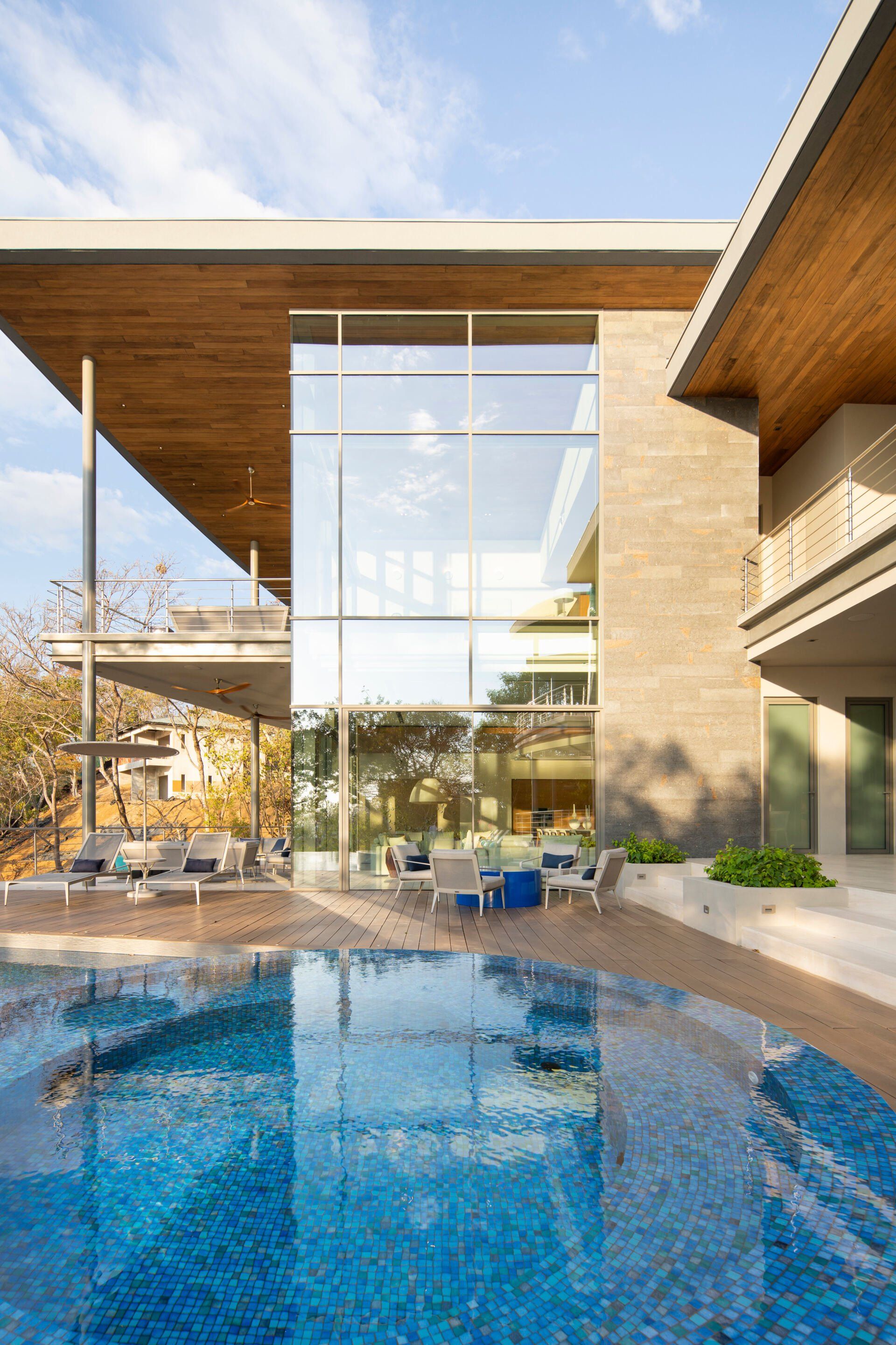 a large house with a large swimming pool in front of it .