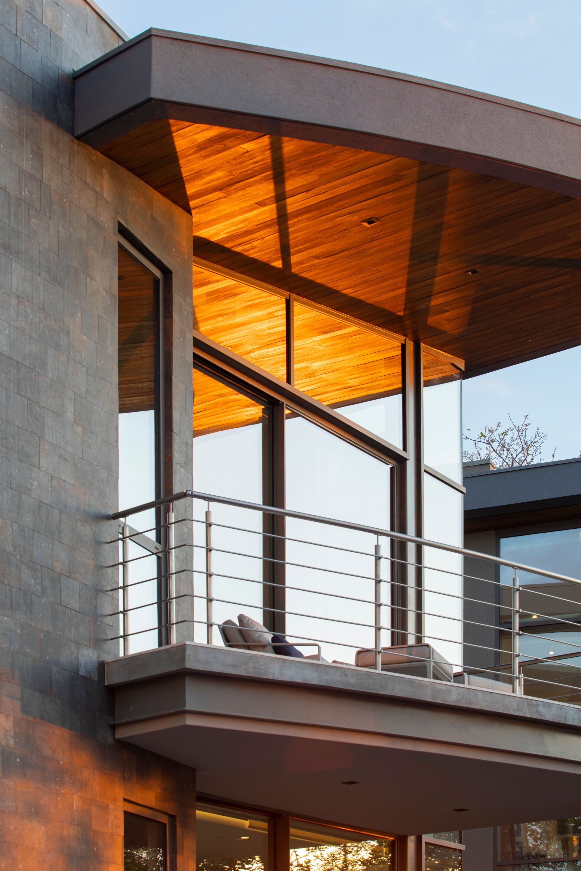 a balcony on the side of a building with a wooden roof