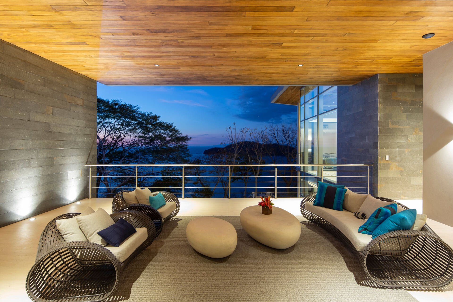 a living room with furniture and a view of the ocean