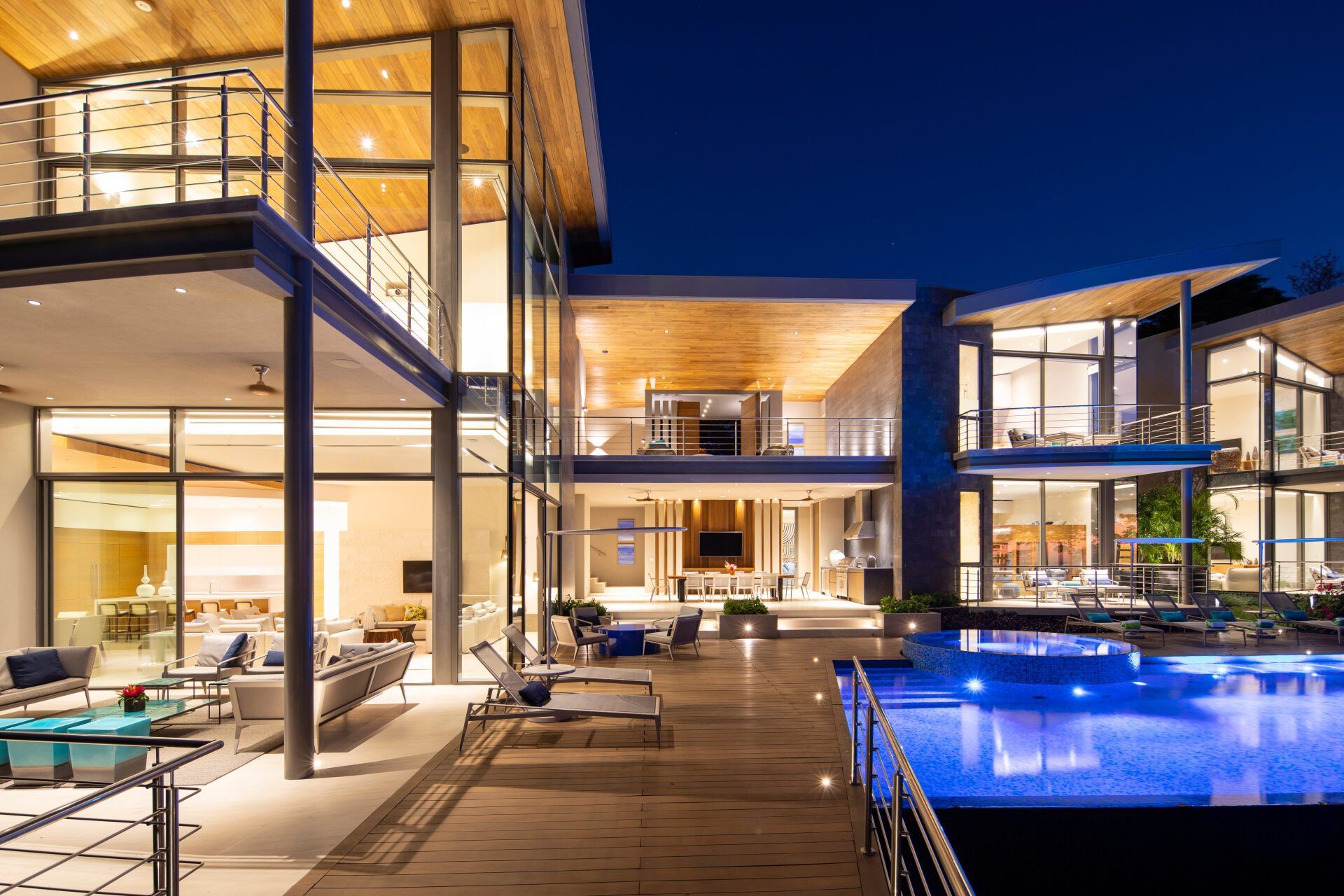 a large house with a swimming pool in front of it at night .