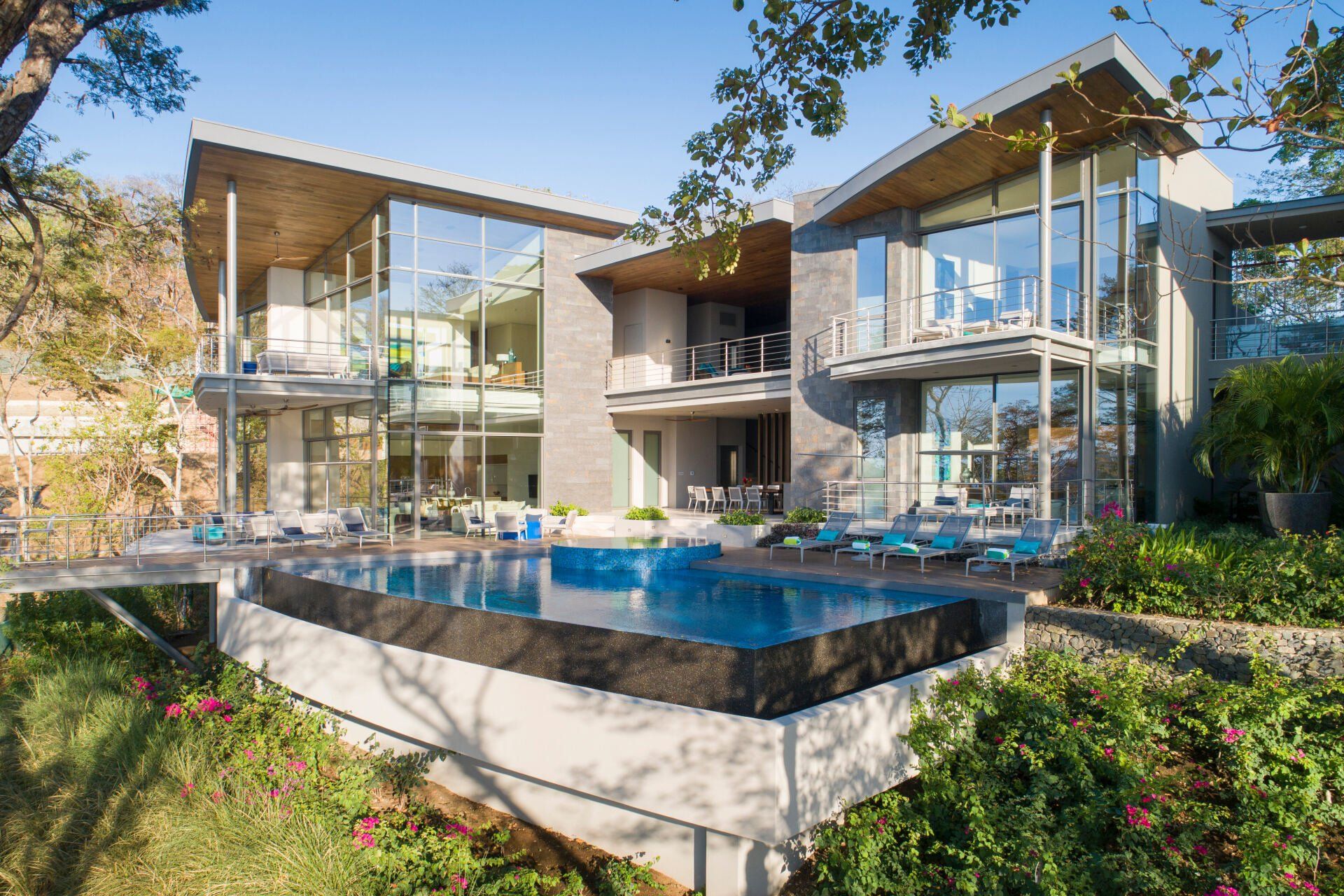 a large house with a swimming pool in front of it