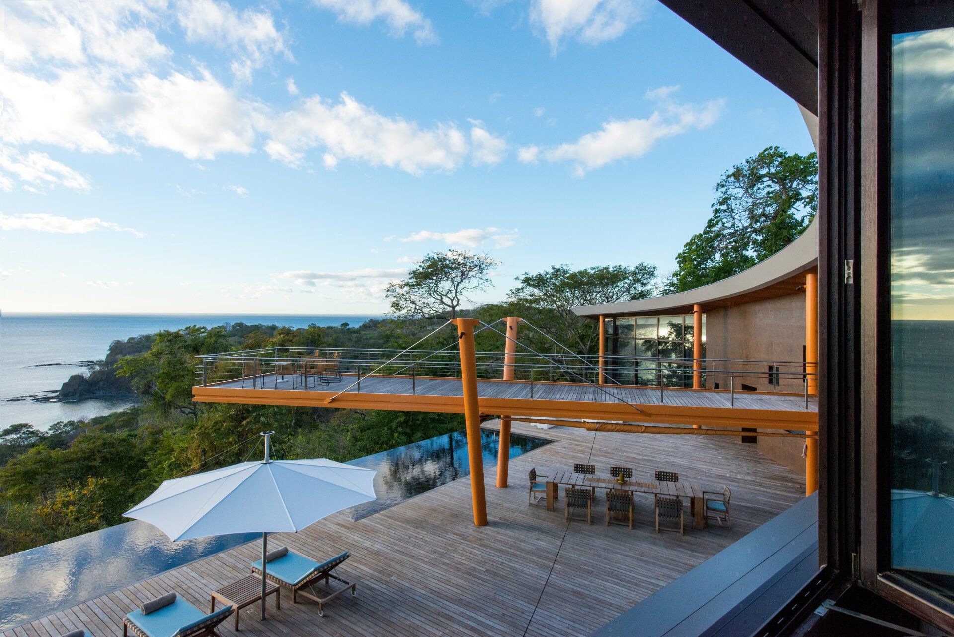 a view of the ocean from a balcony of a house