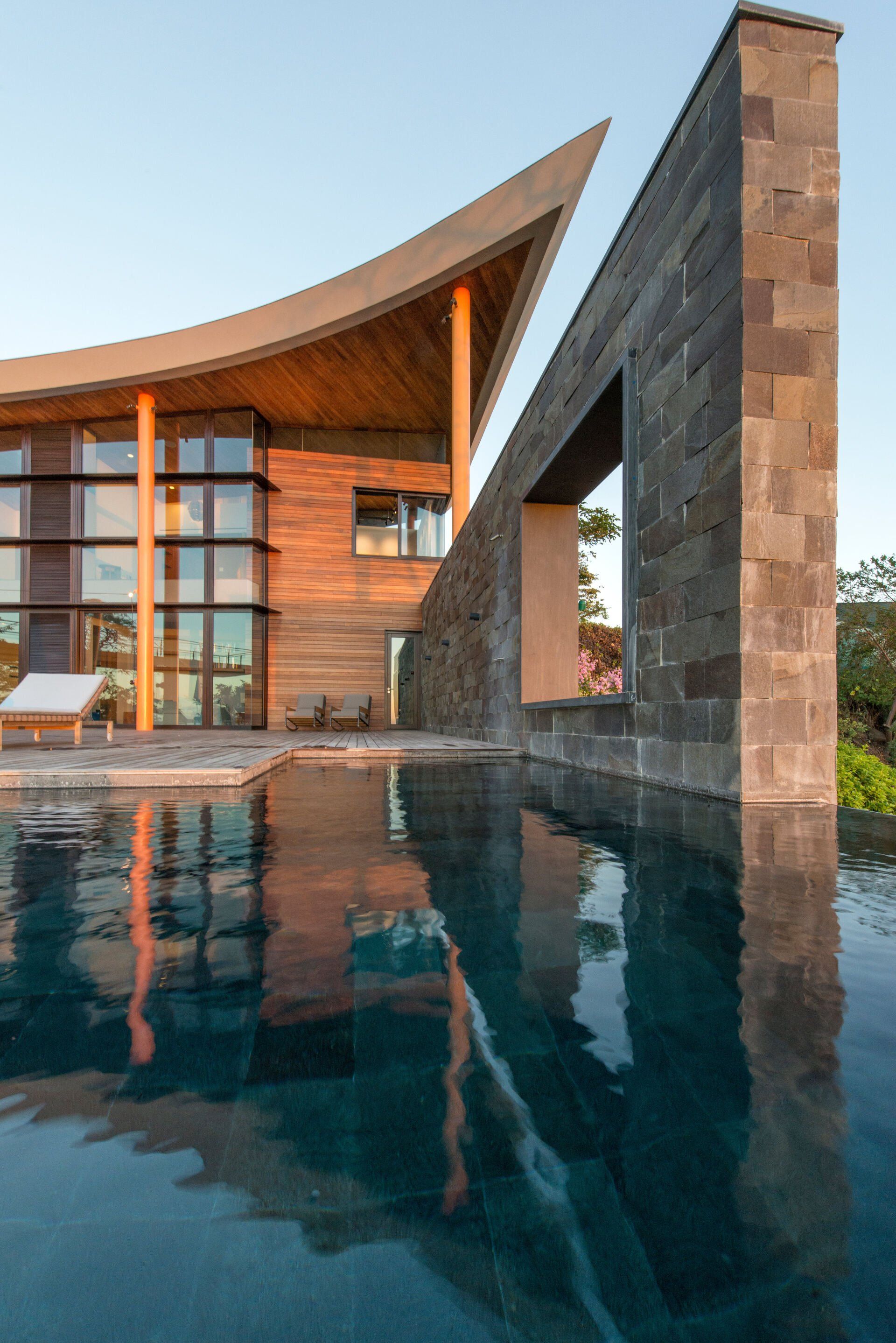 a large house with a swimming pool in front of it