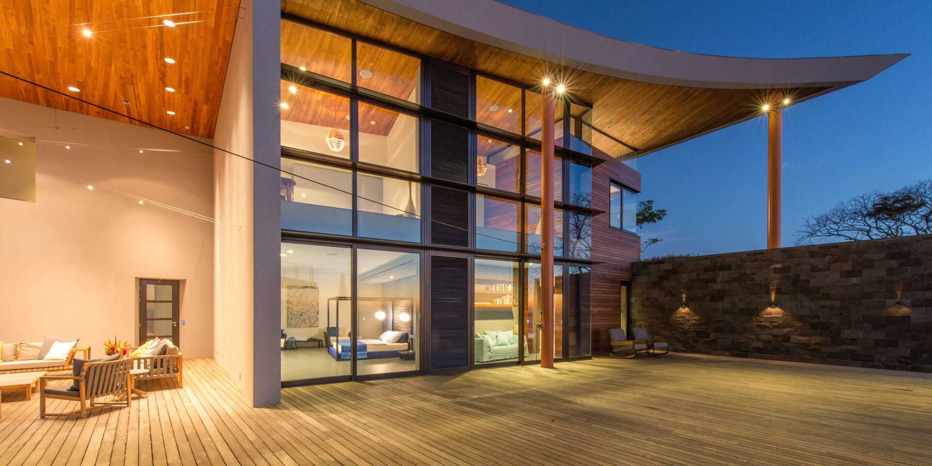 a large house with a lot of windows is lit up at night .