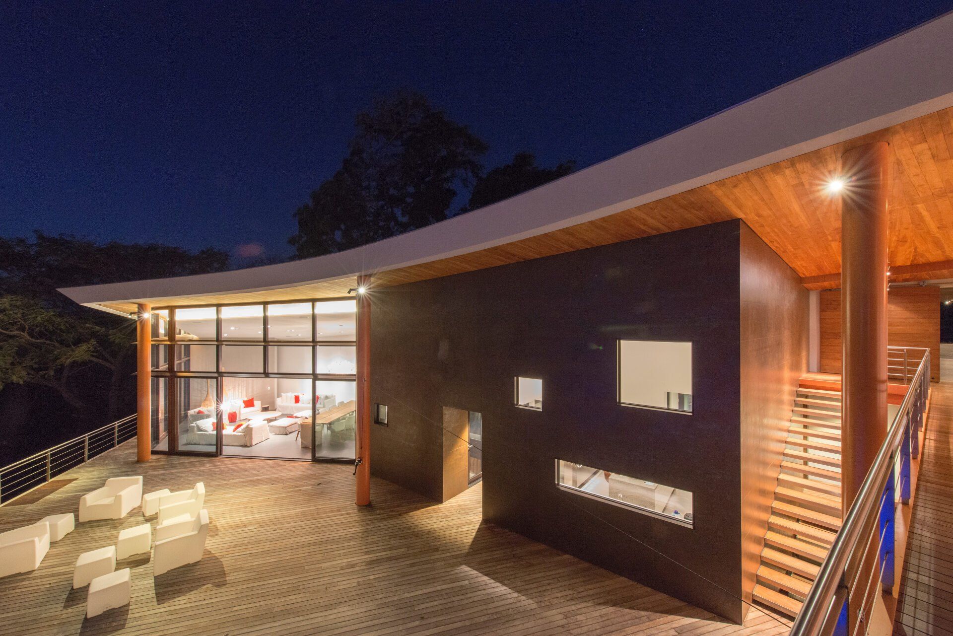 a large house with a lot of windows is lit up at night