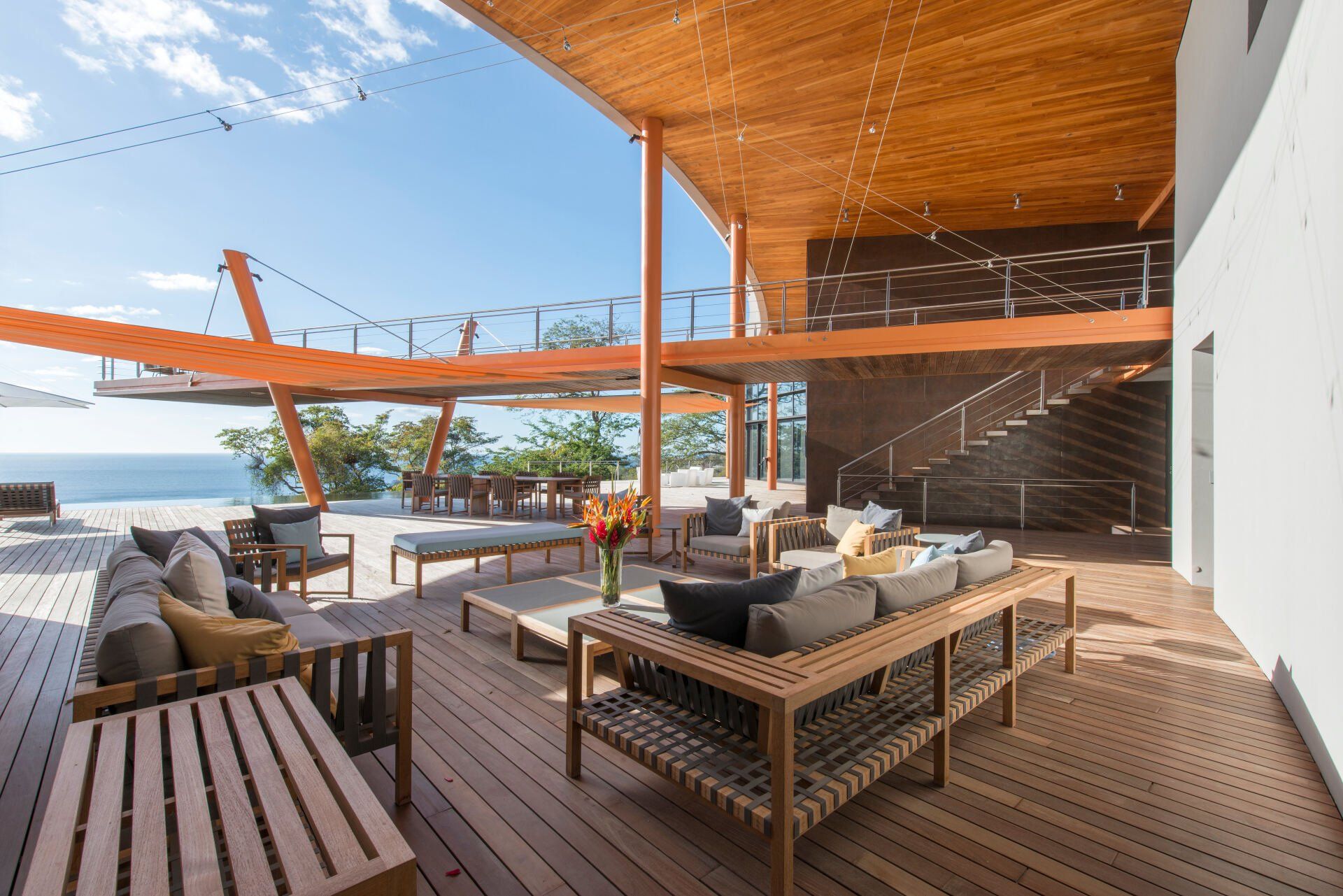 a large wooden deck with a lot of furniture on it .