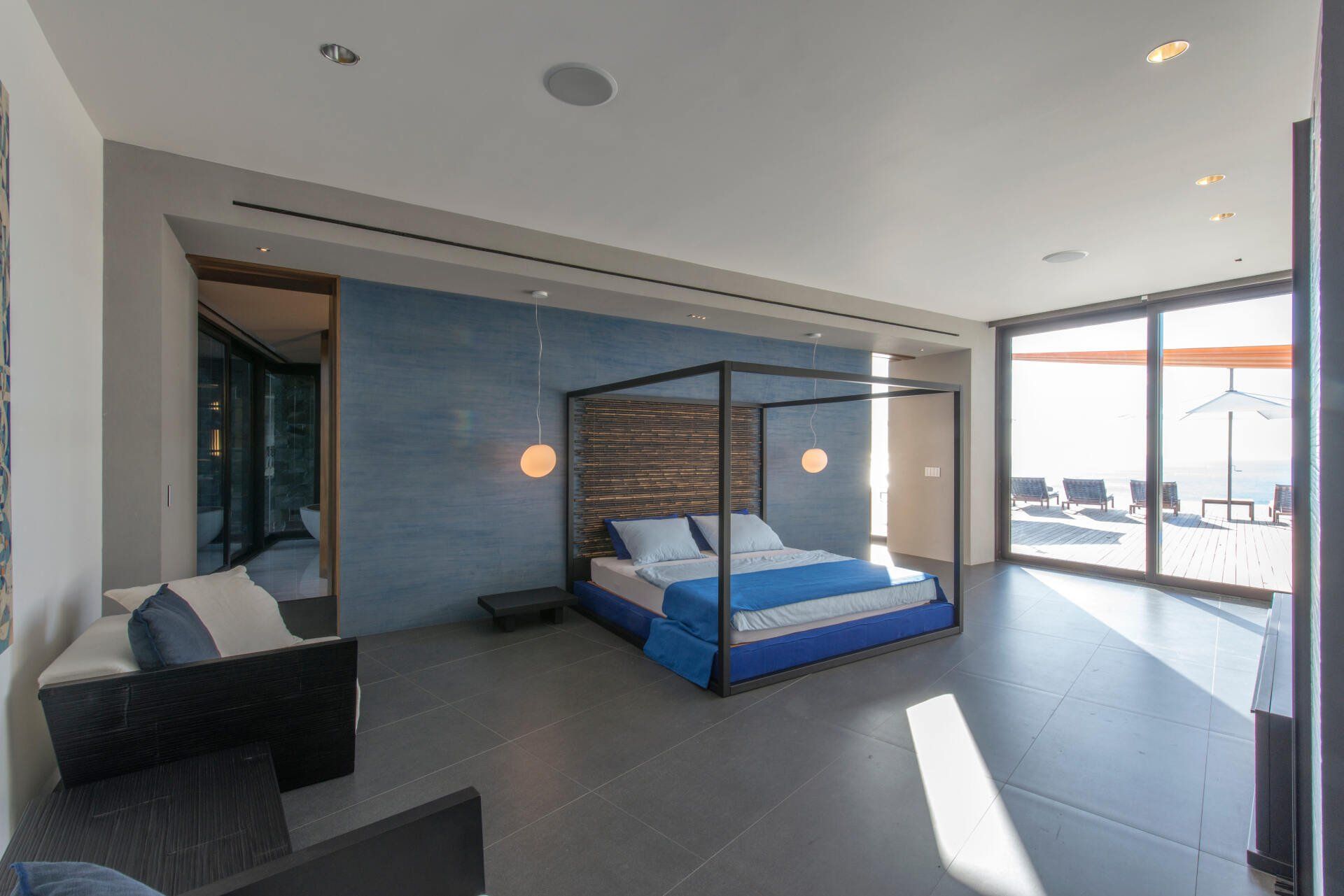 there is a canopy bed in the middle of the room .