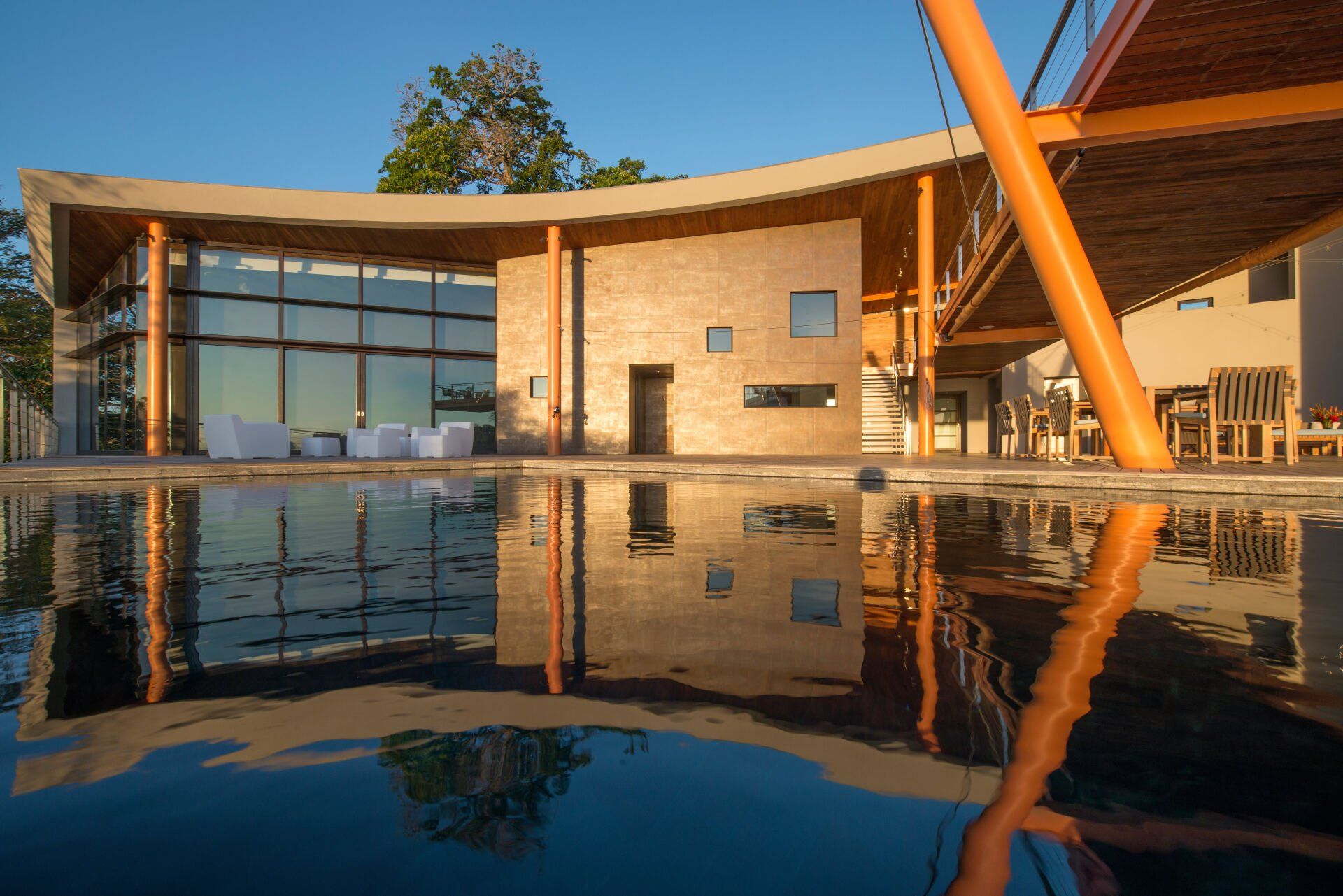 a large house with a swimming pool in front of it