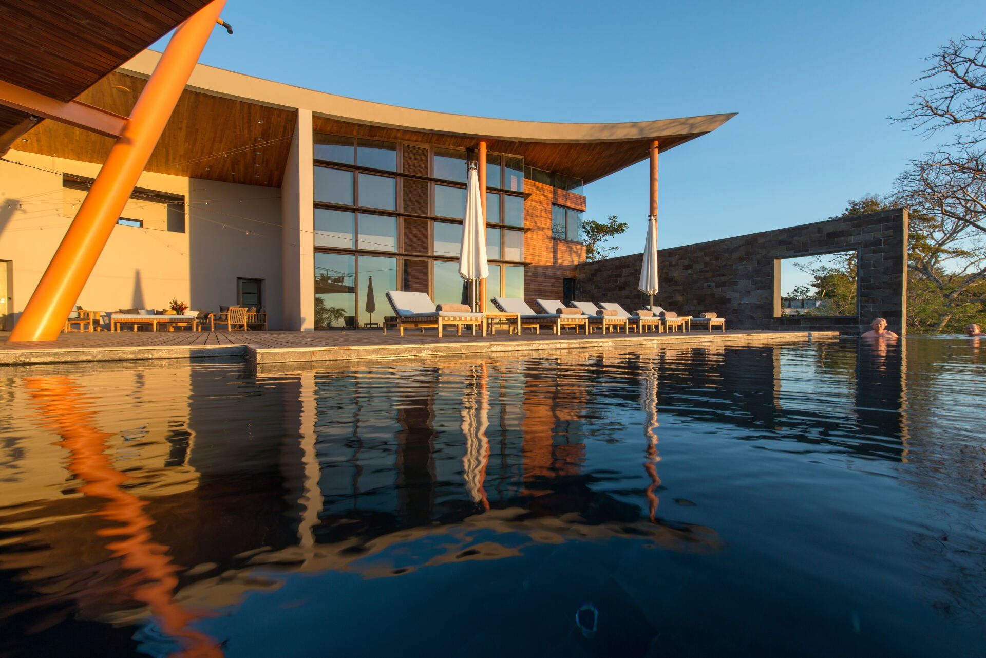 a large building with a swimming pool in front of it
