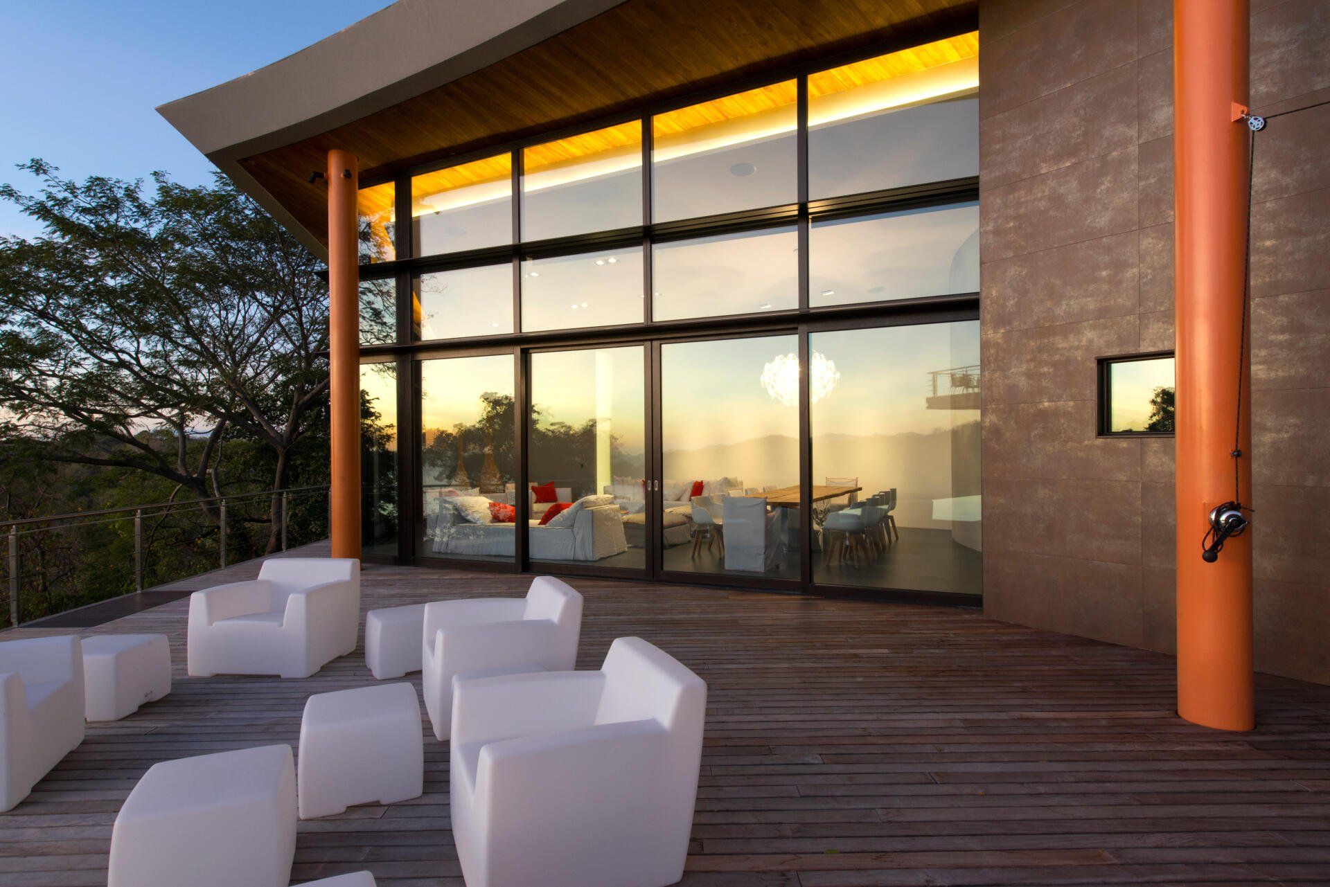 a patio with chairs and tables in front of a large building