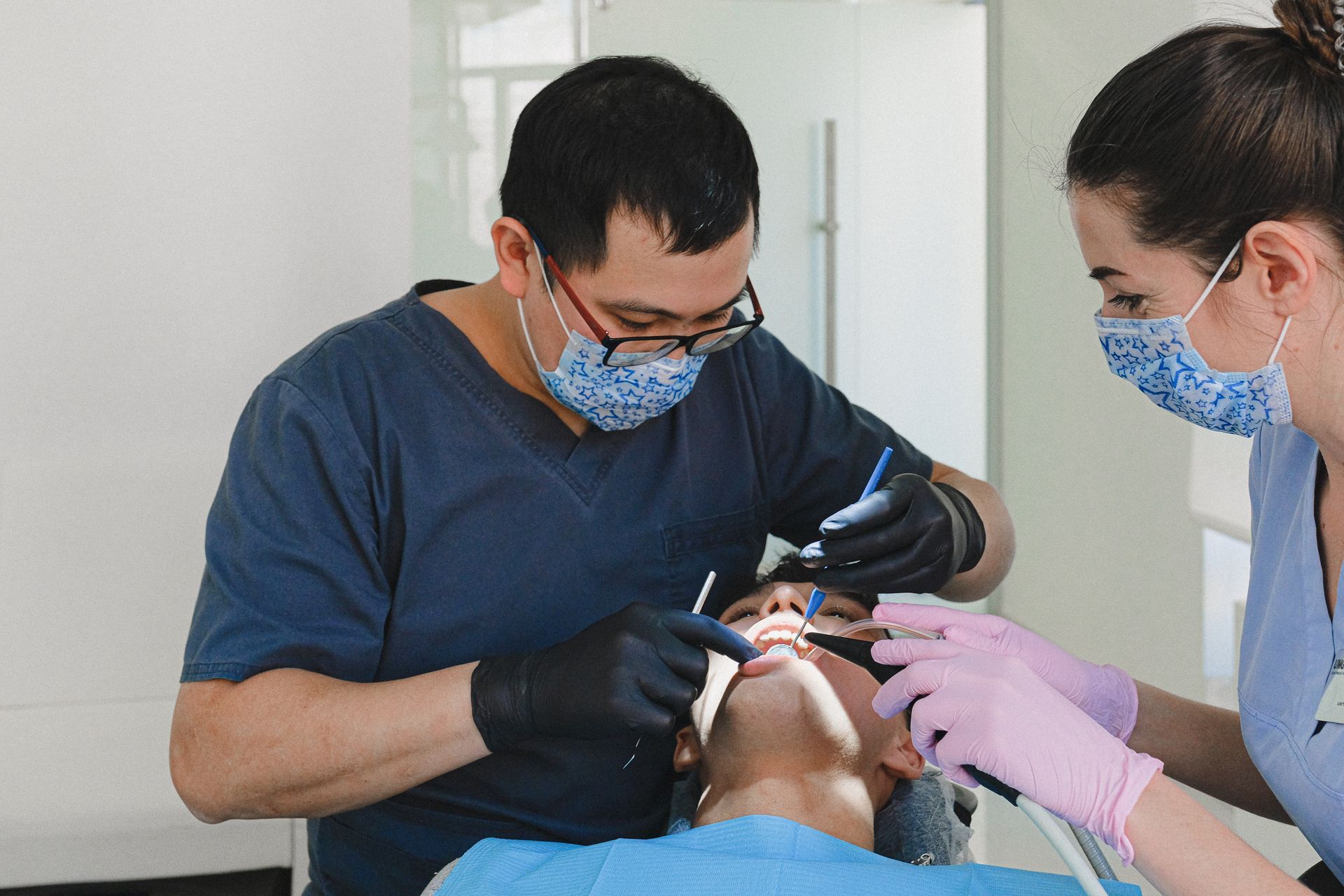 Dentist and Dental Technichian examining patient