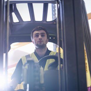 operator driving fork lift truck