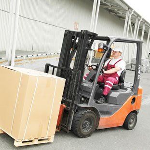 forklift truck moving large packing case