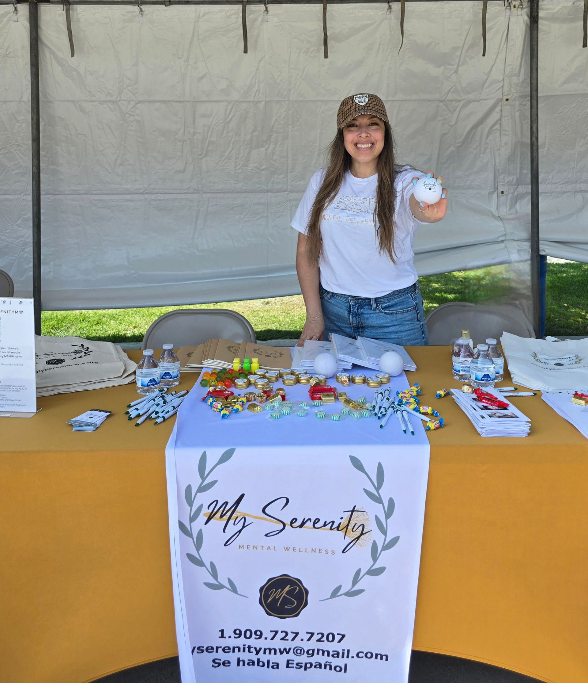 A woman is holding two small birds on her shoulder.