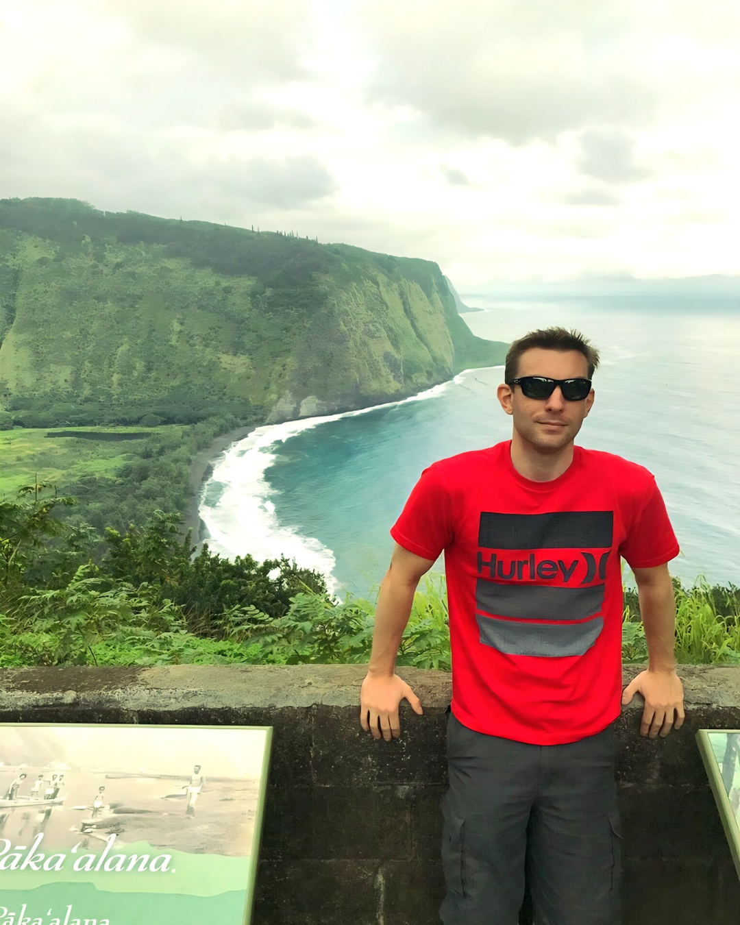 Woman wearing Minnie Mouse ears in front of a castle, posing with hand on hip.