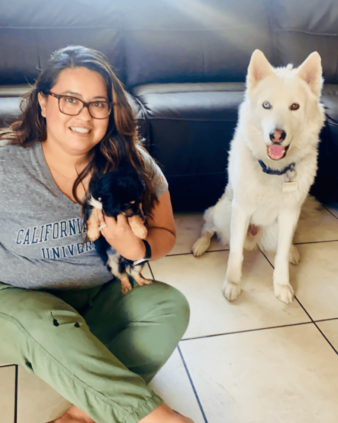 Woman wearing Minnie Mouse ears in front of a castle, posing with hand on hip.