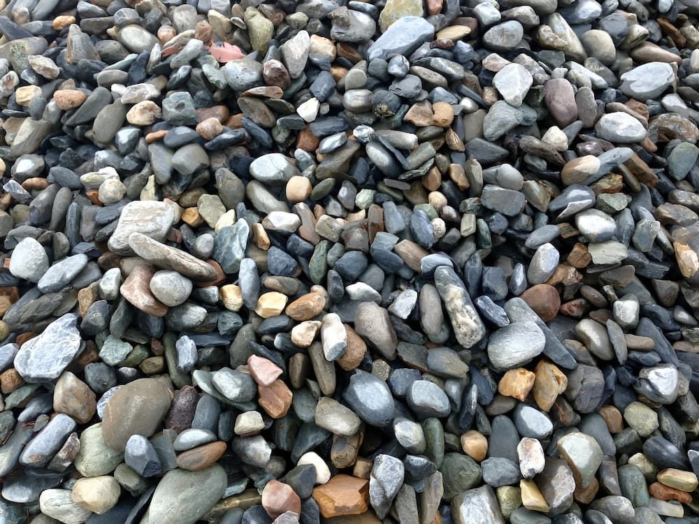 A Pile Of Rocks Of Different Sizes And Colors On The Ground — S & K Raw Materials & Earthmoving in Atherton, QLD