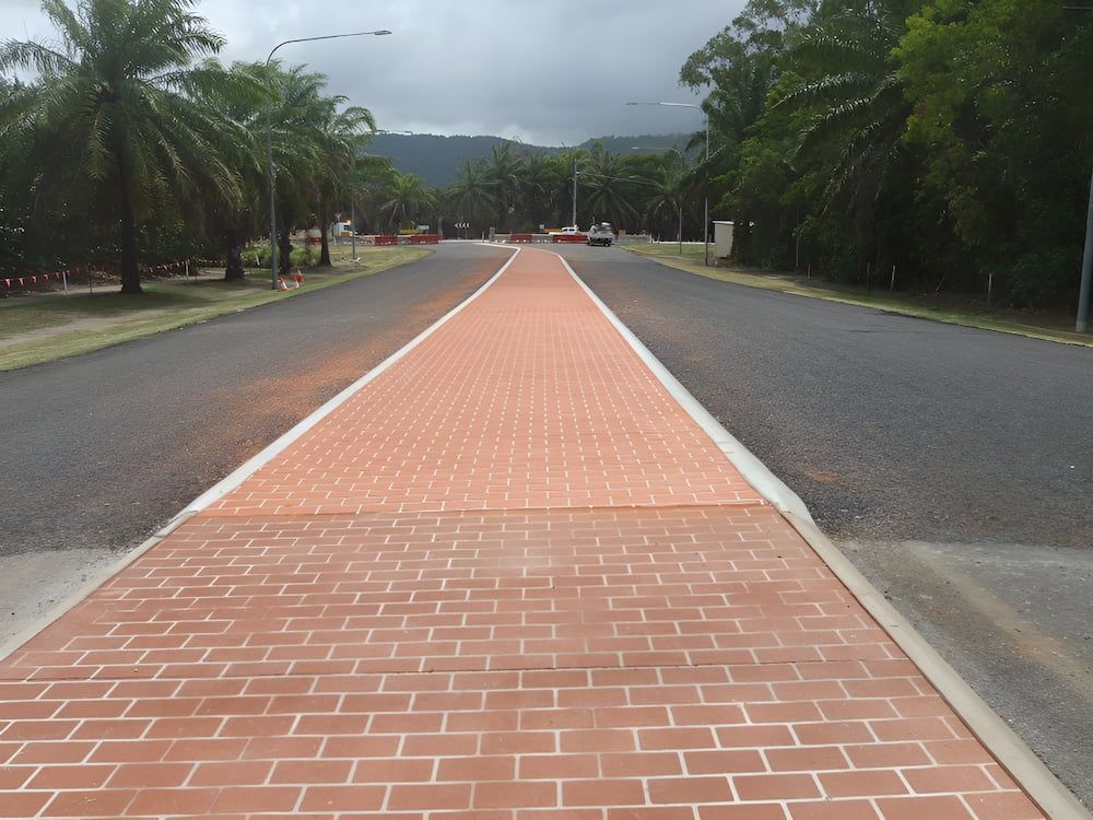 A Brick Walkway On The Side Of A Road — S & K Raw Materials & Earthmoving in Mareeba, QLD