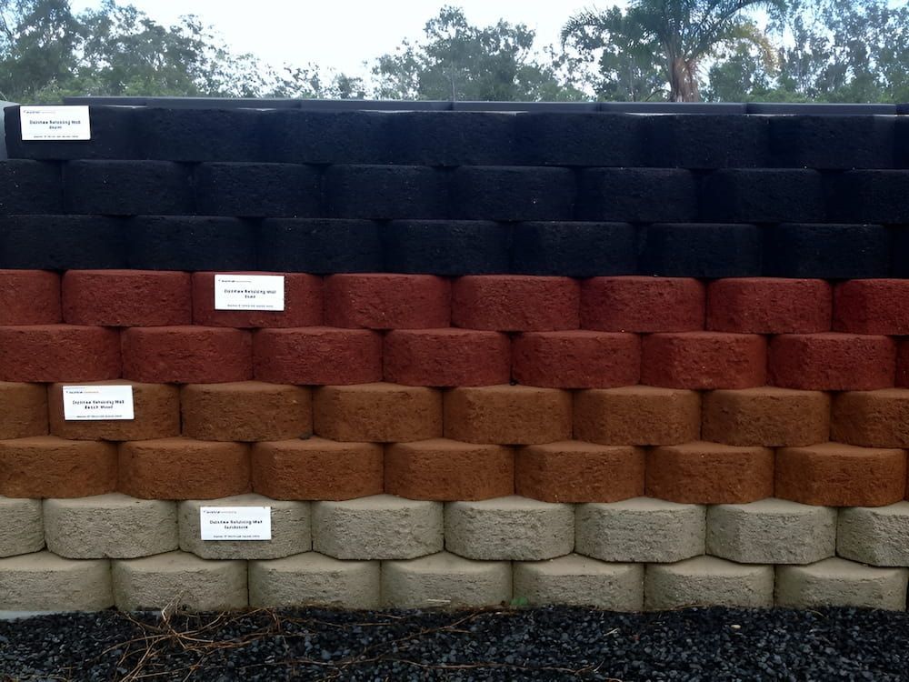 A Row Of Bricks Of Different Colors Are Lined Up In A Row — S & K Raw Materials & Earthmoving in Atherton, QLD