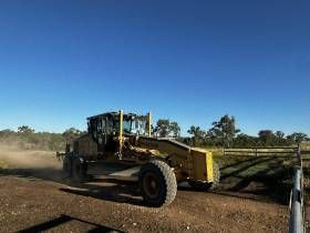 A Yellow Bulldozer Is Parked In A Dirt Lot — S & K Raw Materials & Earthmoving in Atherton, QLD