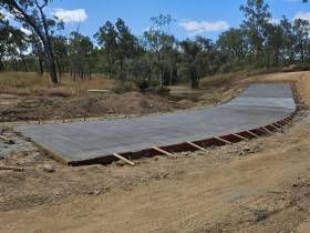A Concrete Walkway Is Being Built With A Wooden Border — S & K Raw Materials & Earthmoving in Atherton, QLD