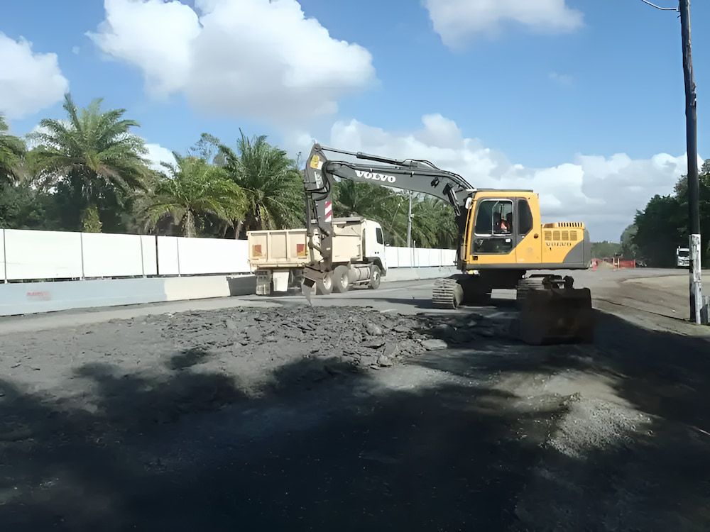 A Volvo Excavator Is Working On A Road — S & K Raw Materials & Earthmoving in Atherton, QLD