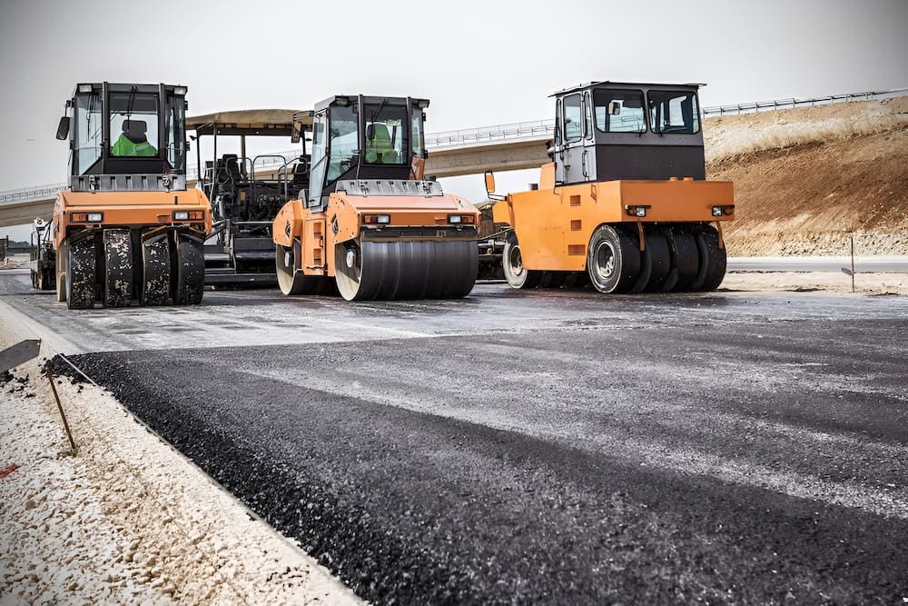 Three Asphalt Rollers Are Working On A Road Under Construction — S & K Raw Materials & Earthmoving in Atherton, QLD